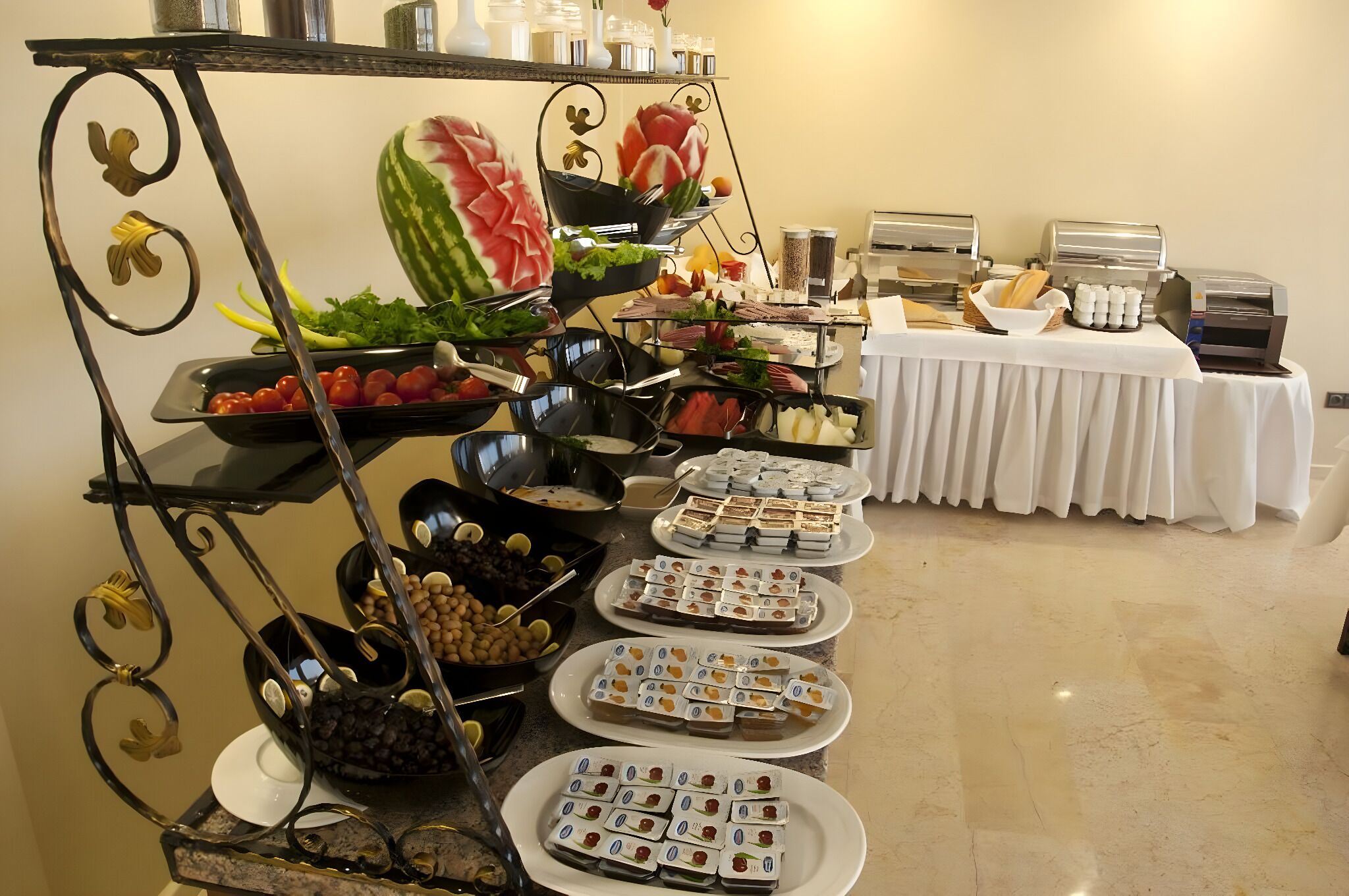 A buffet setup with various food items and a coffee station.