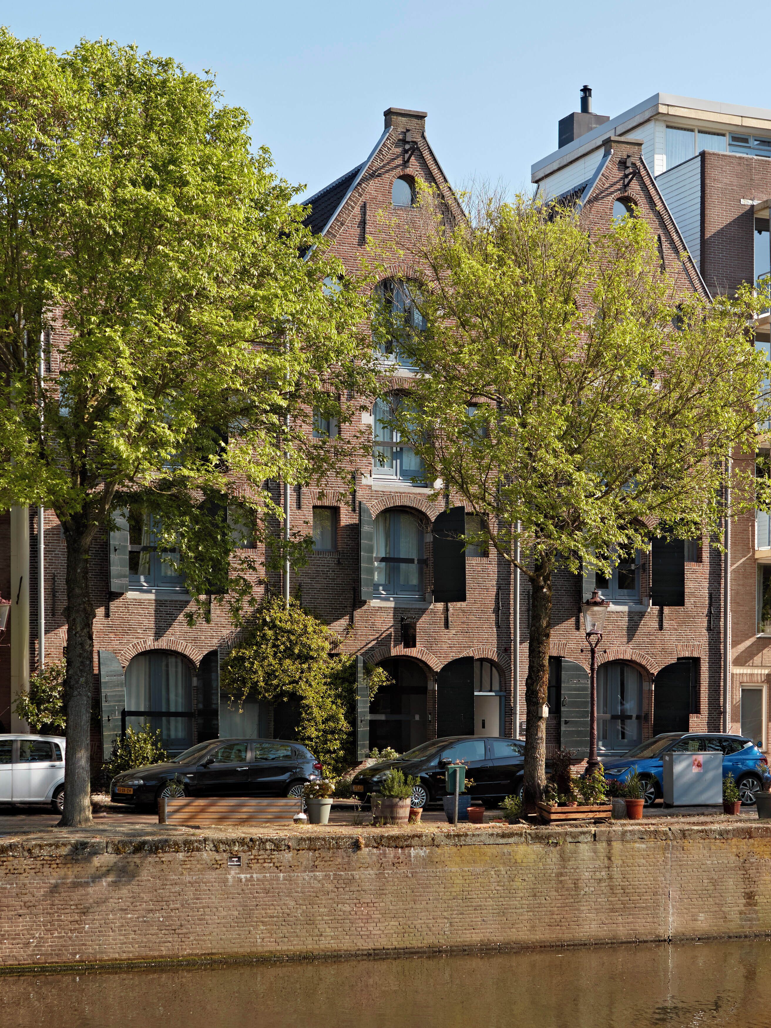A multi-story building with a brick facade, large windows, and a flat roof.