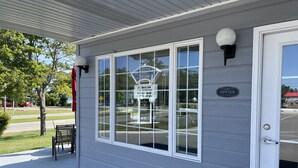 A building with a sign reading "Office" and a "Welcome" sign on the door. - Lighthouse View Motel (Mackinaw City)
