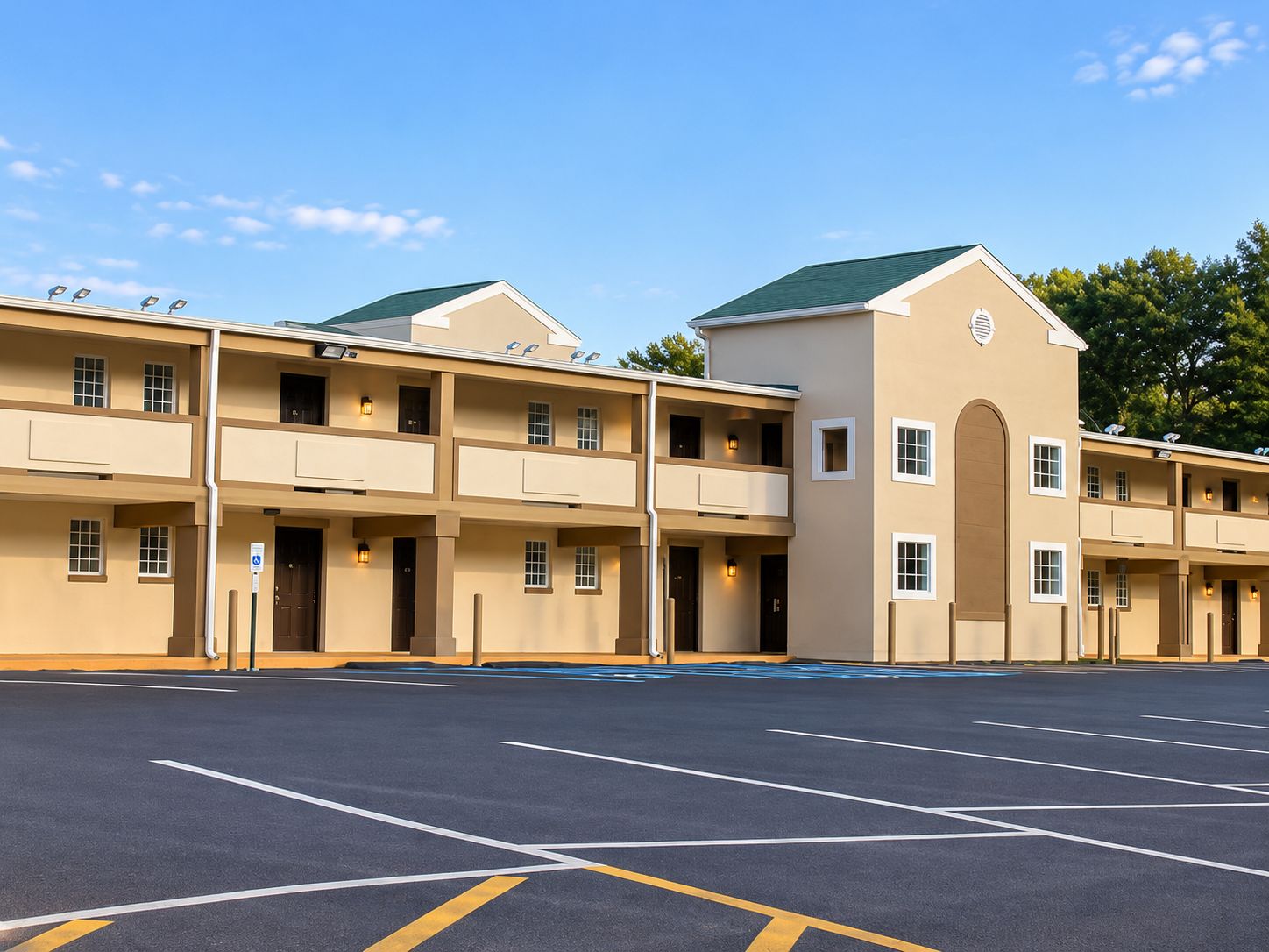 A multi-story hotel with a parking lot in front.