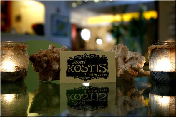 A sign for Hotel Kostis with a contact number.