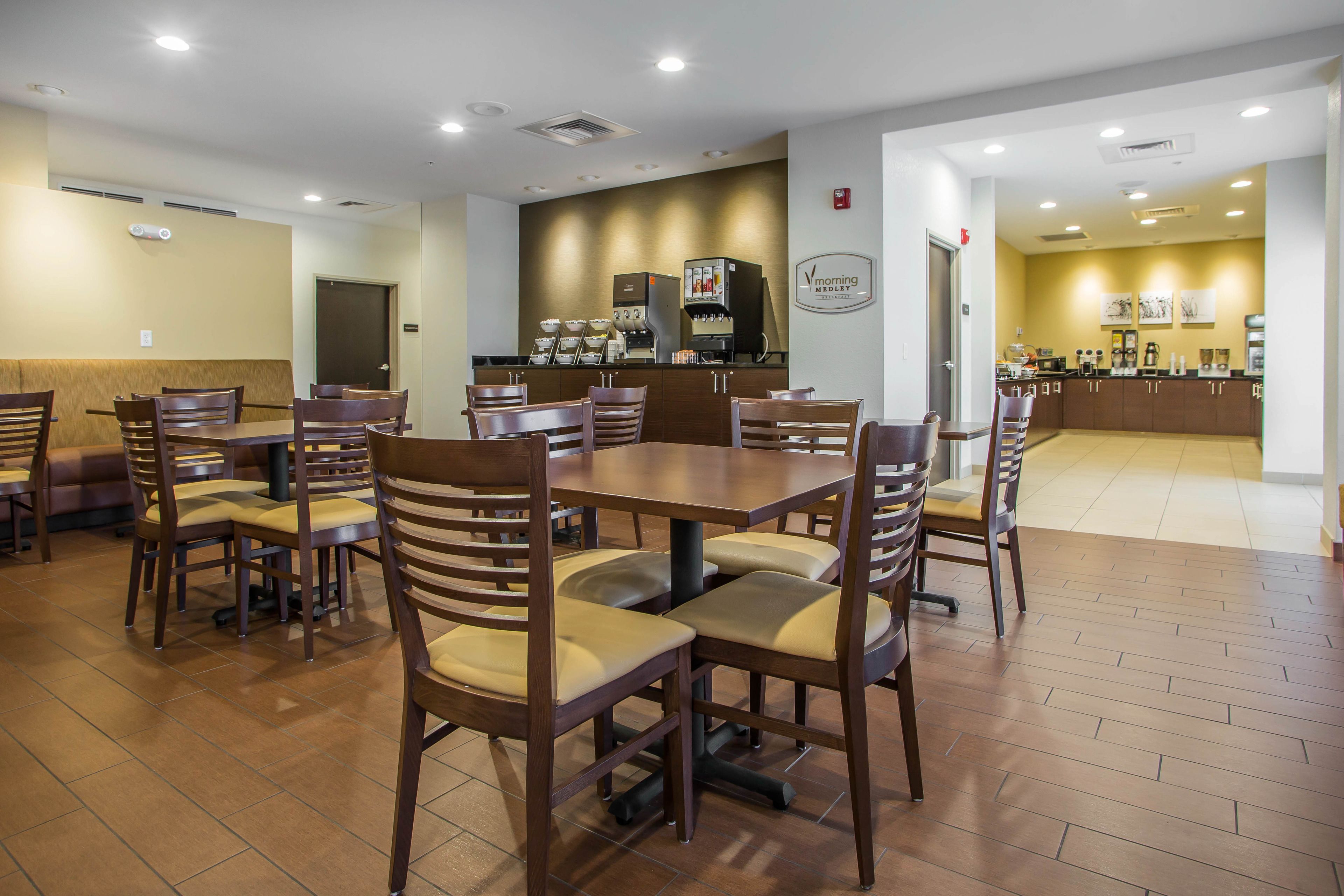 A restaurant with wooden tables and chairs, a coffee bar, and a sign reading "Morning Medley."