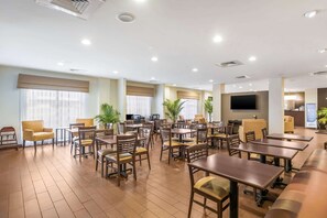 Relax in our spacious lobby with seating areas for individual and group gatherings, a flat-screen TV, and lush greenery.