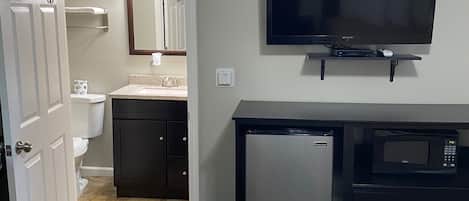 Desk, iron/ironing board, bed sheets