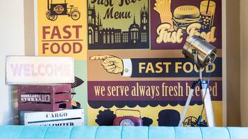 A wall with various fast food signs and a vintage radio.