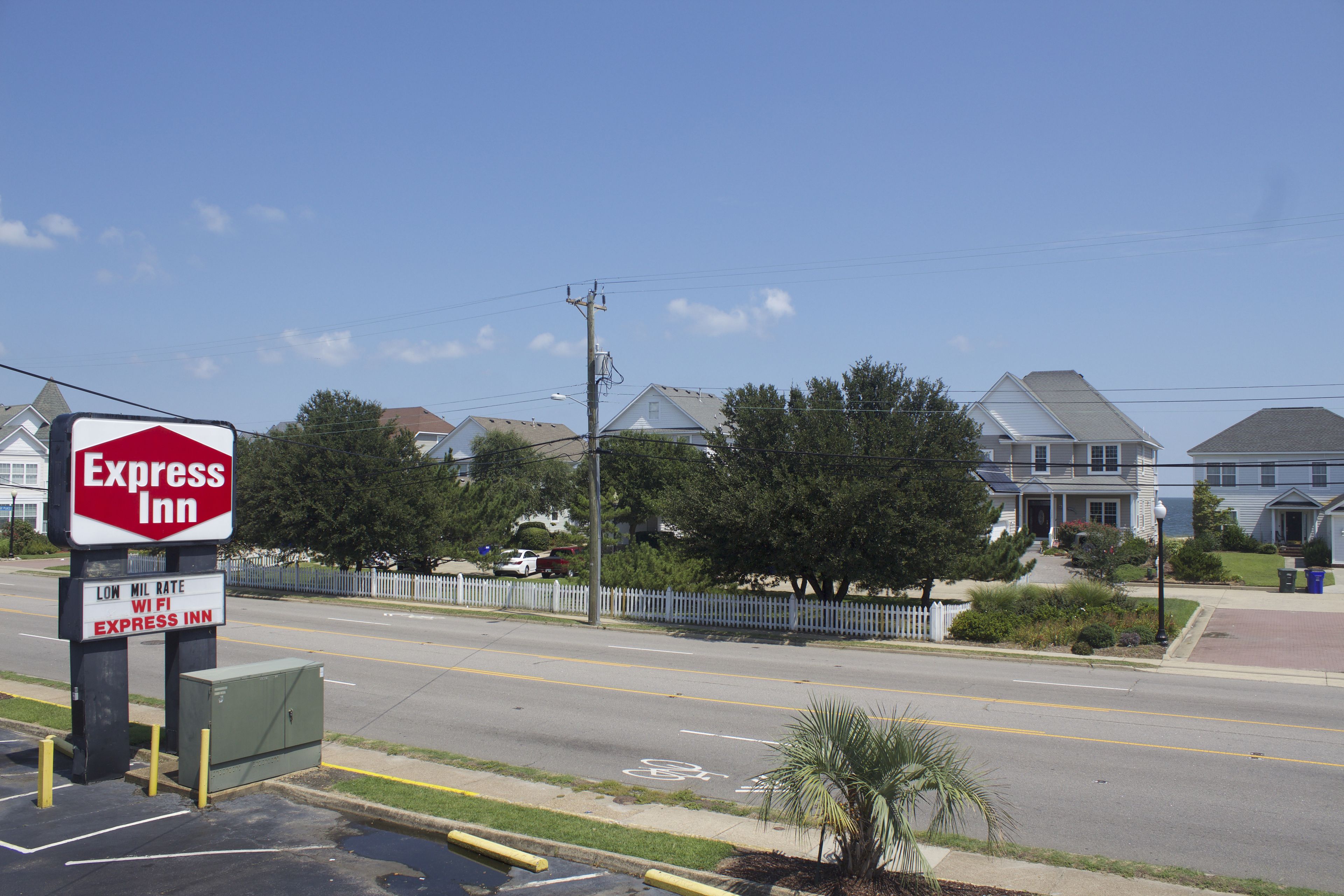 A street view with a sign for Express Inn, a low-mile rate, and WiFi availability.