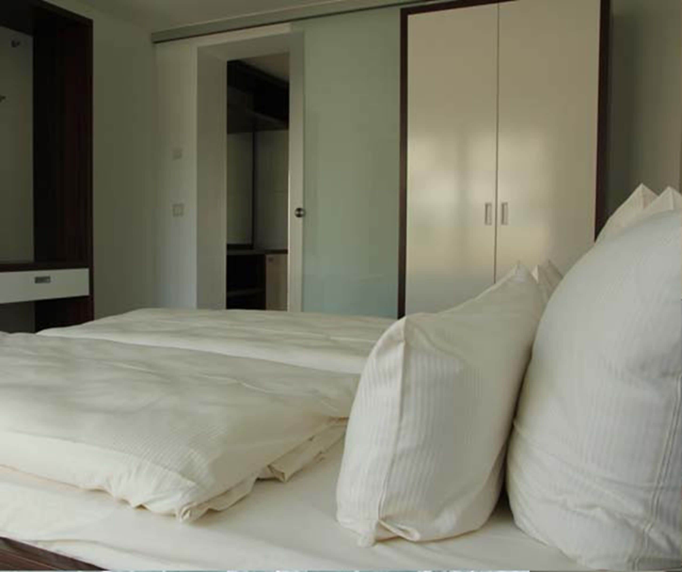 apartment, 1 bedroom, lake view | minibar, in-room safe, blackout curtains, iron/ironing board