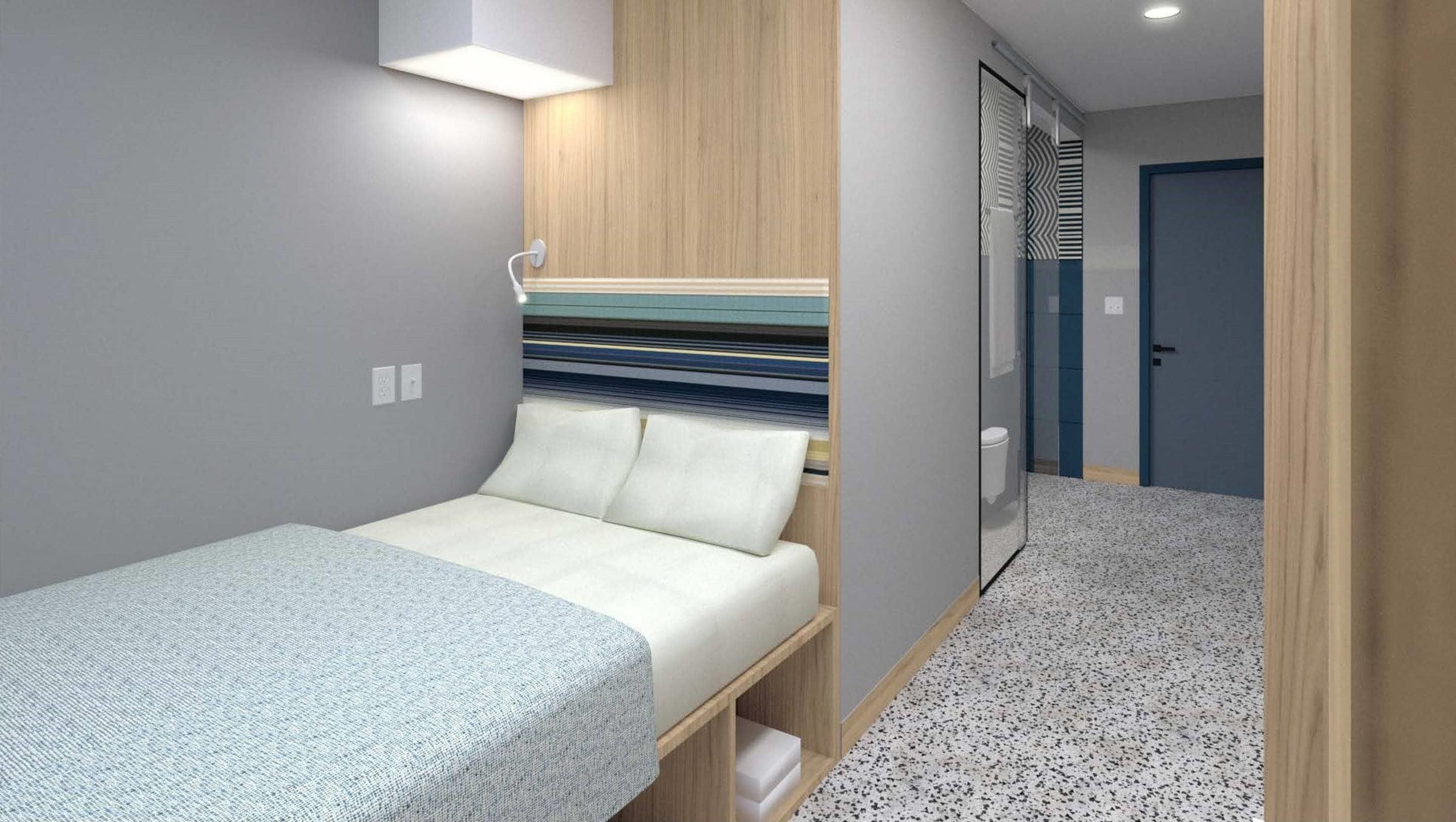 Um quarto pequeno e funcional, com uma cama, uma escrivaninha e um guarda-roupa.