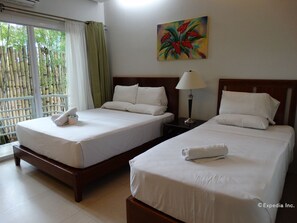 Deluxe Triple Room | Desk, blackout drapes, rollaway beds, bed sheets - Greenspace Palawan Hotel (Puerto Princesa)