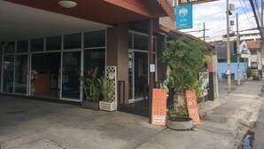A building with a sign for 'The Chateau Chiangmai Residence' and an ATM sign.