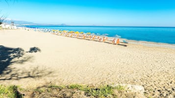 On the beach, sun-loungers, beach umbrellas