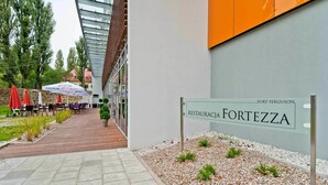 A restaurant named 'Fortezza' with outdoor seating and a pathway leading to it. - Hotel Forza (Poznan)