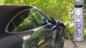 A black car parked next to an electric charging station with the brand 'enel x' visible. - Ginestriccio (Bibbona)