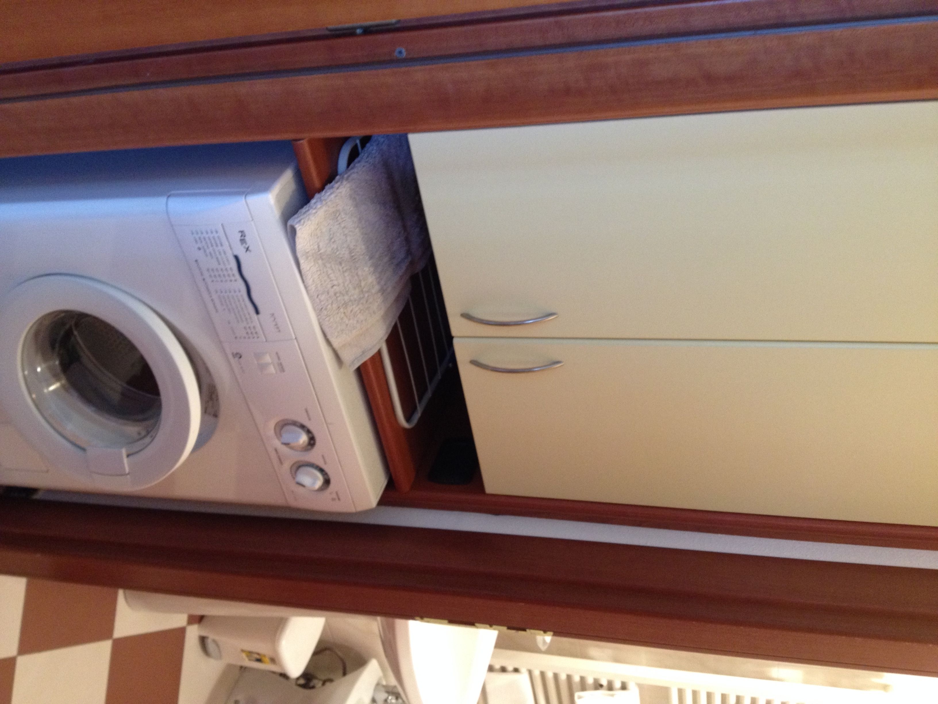 A washing machine and a cabinet in a laundry area.