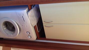 A washing machine and a cabinet in a laundry area.