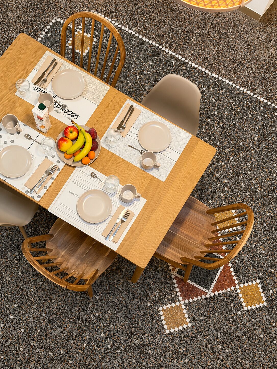 A dining table set with plates, cutlery, and a fruit bowl, surrounded by chairs.