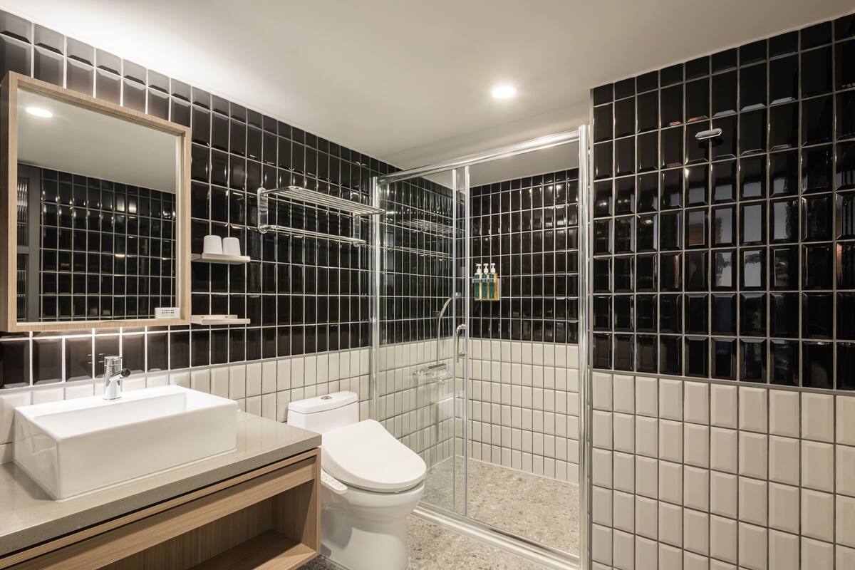 shower, hair dryer, slippers, towels