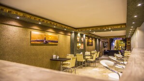 A hotel lobby with a long reception desk, multiple seating areas, and a large painting on the wall. - Berlin Otel Nişantaşı (Istanbul)