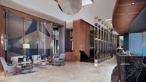 A modern lobby with a seating area, a reception desk, and a staircase. - Delta Hotels By Marriott Istanbul Levent (Istanbul)