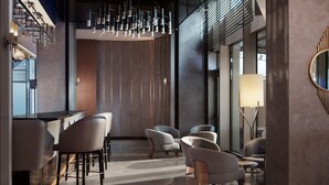 A modern interior with a bar area, seating, and a large mirror. - Delta Hotels By Marriott Istanbul Levent (Istanbul)