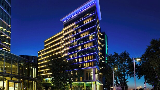 A multi-story hotel with a modern design, featuring illuminated signage and a well-lit entrance. - Delta Hotels By Marriott Istanbul Levent (Istanbul)