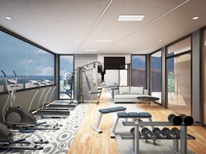A modern gym with cardio equipment, weight benches, and dumbbells. - The Win Place (Chiang Mai)