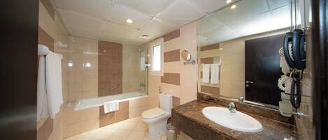 A modern bathroom with a bathtub, toilet, and sink.