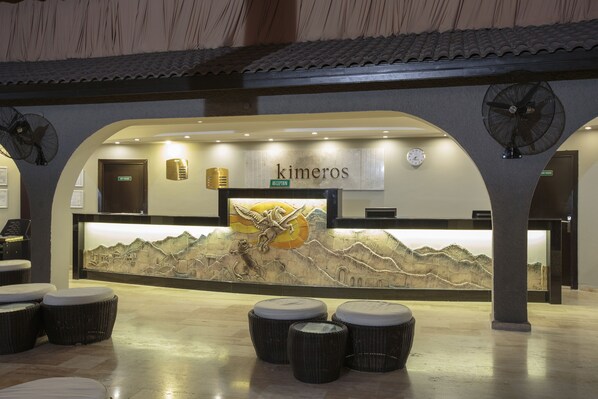 A reception area with a mural, a reception desk, and seating.