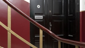 A black door with a brass handrail leading to it. - Prior Suites Split (Split)