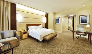 A hotel room with a large bed, a desk, a chair, a nightstand, and a mirror. - Conrad Jabal Omar Makkah (Makkah)