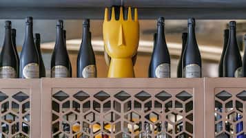 A wine rack with bottles and decorative yellow figures.
