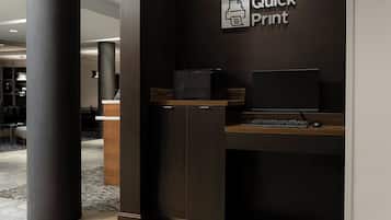 A modern office space with a desk, computer, and printer labeled "Quick Print".