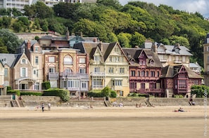 A row of colorful, historic buildings along a riverside.