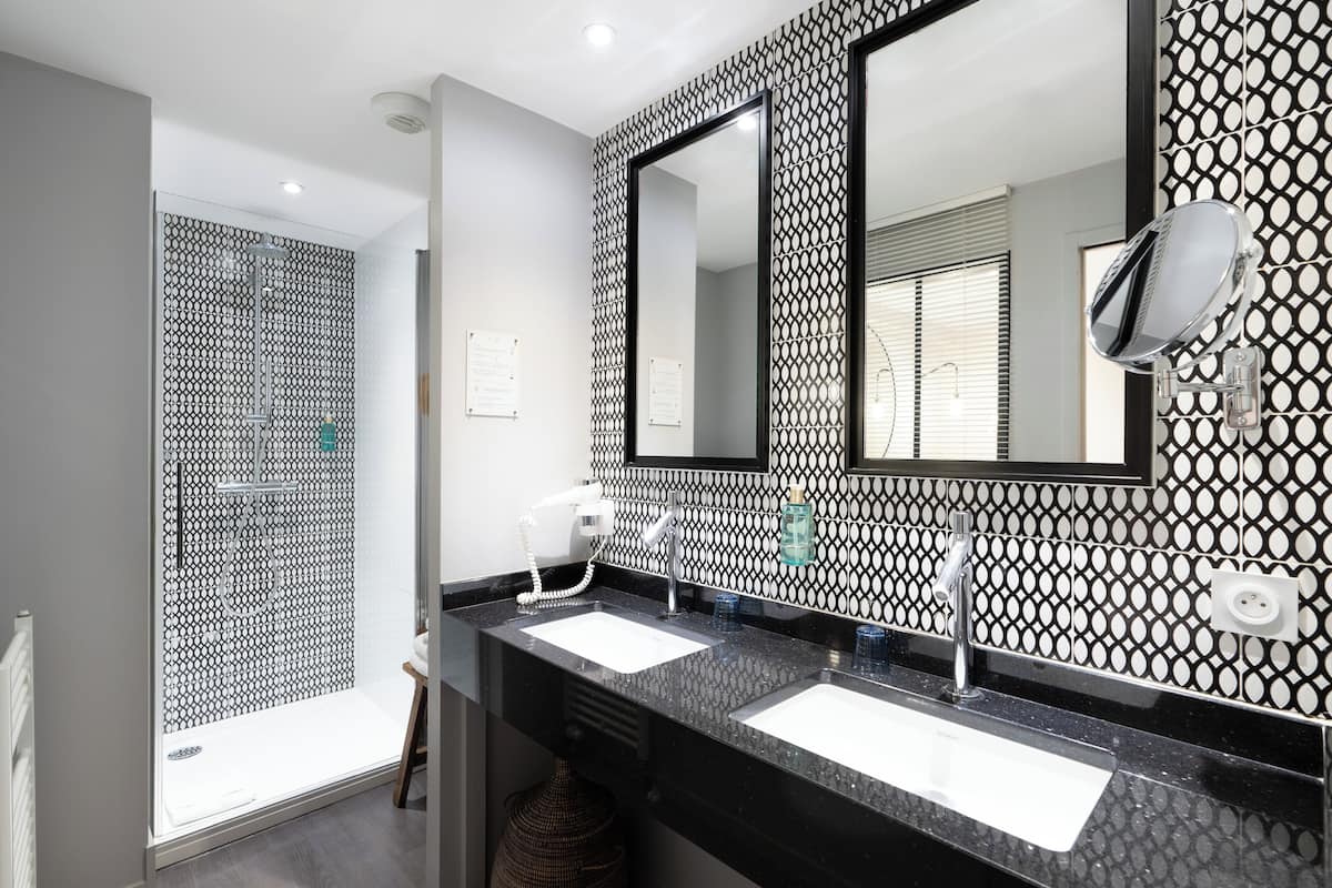 premium suite, 1 king bed with sofa bed | bathroom | shower, eco-friendly toiletries, hair dryer, towels