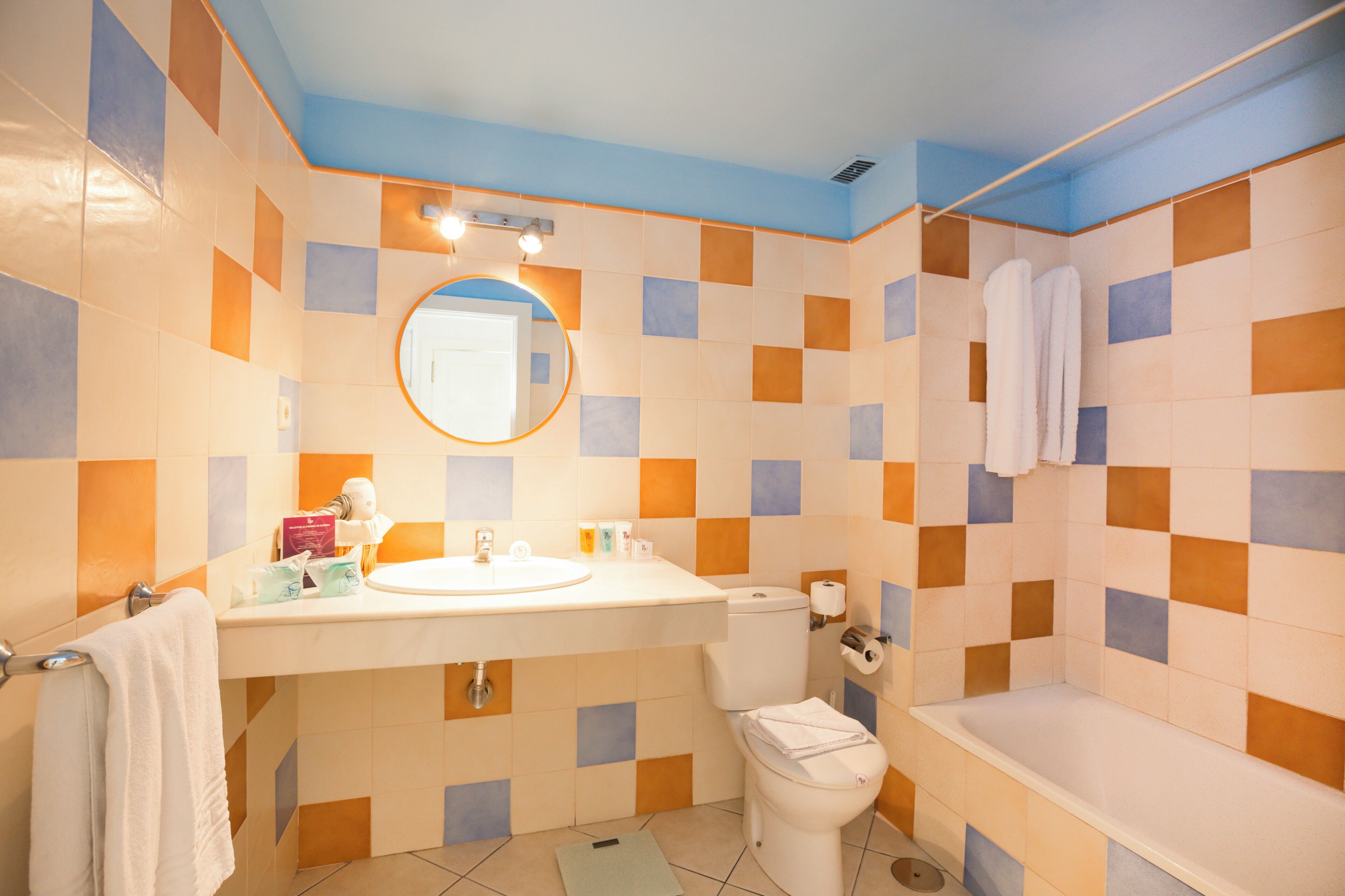 A bathroom with a sink, toilet, and bathtub.