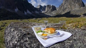 A picnic setup on a rock with a mountain view.