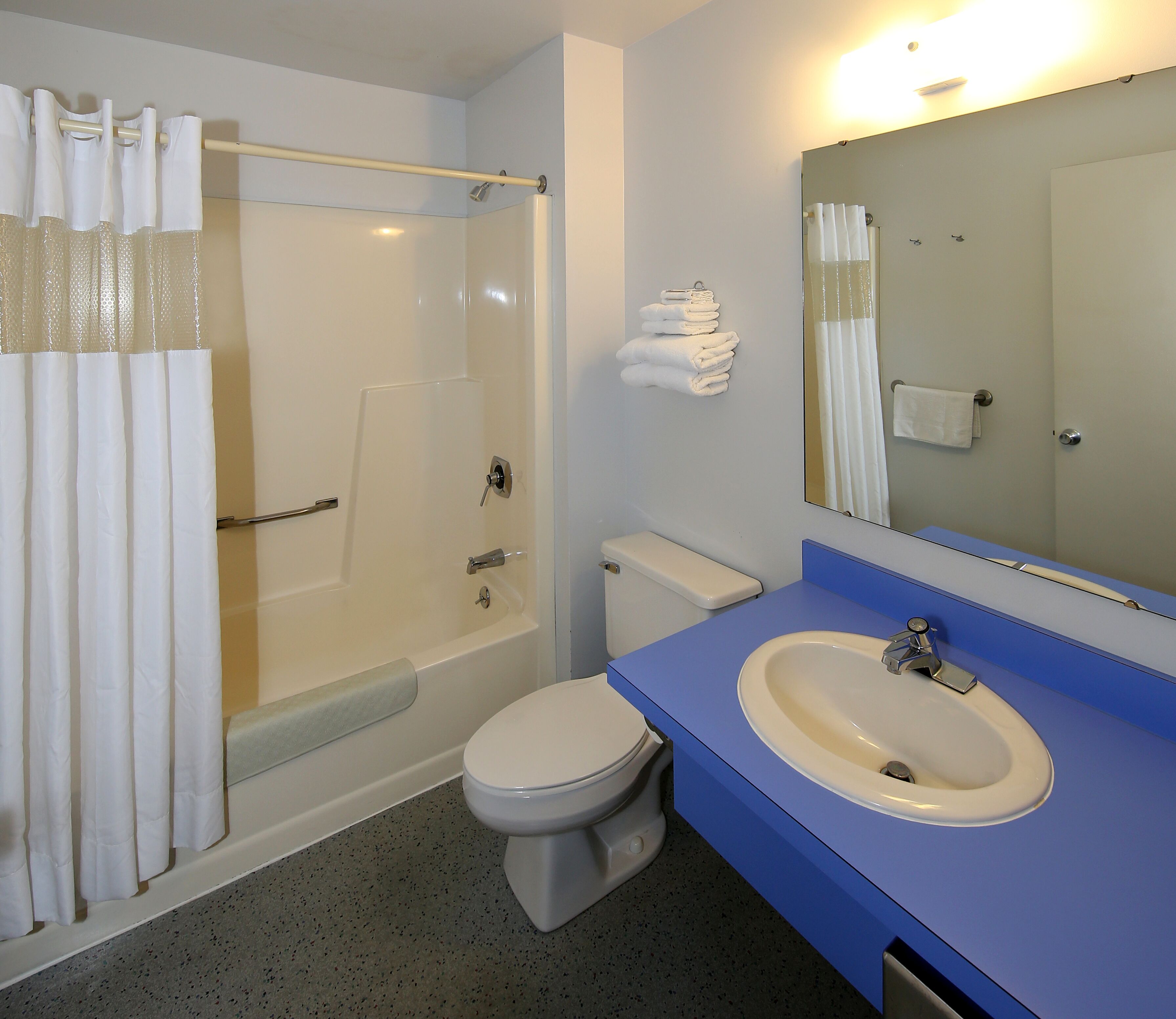 A bathroom with a bathtub, toilet, and sink.