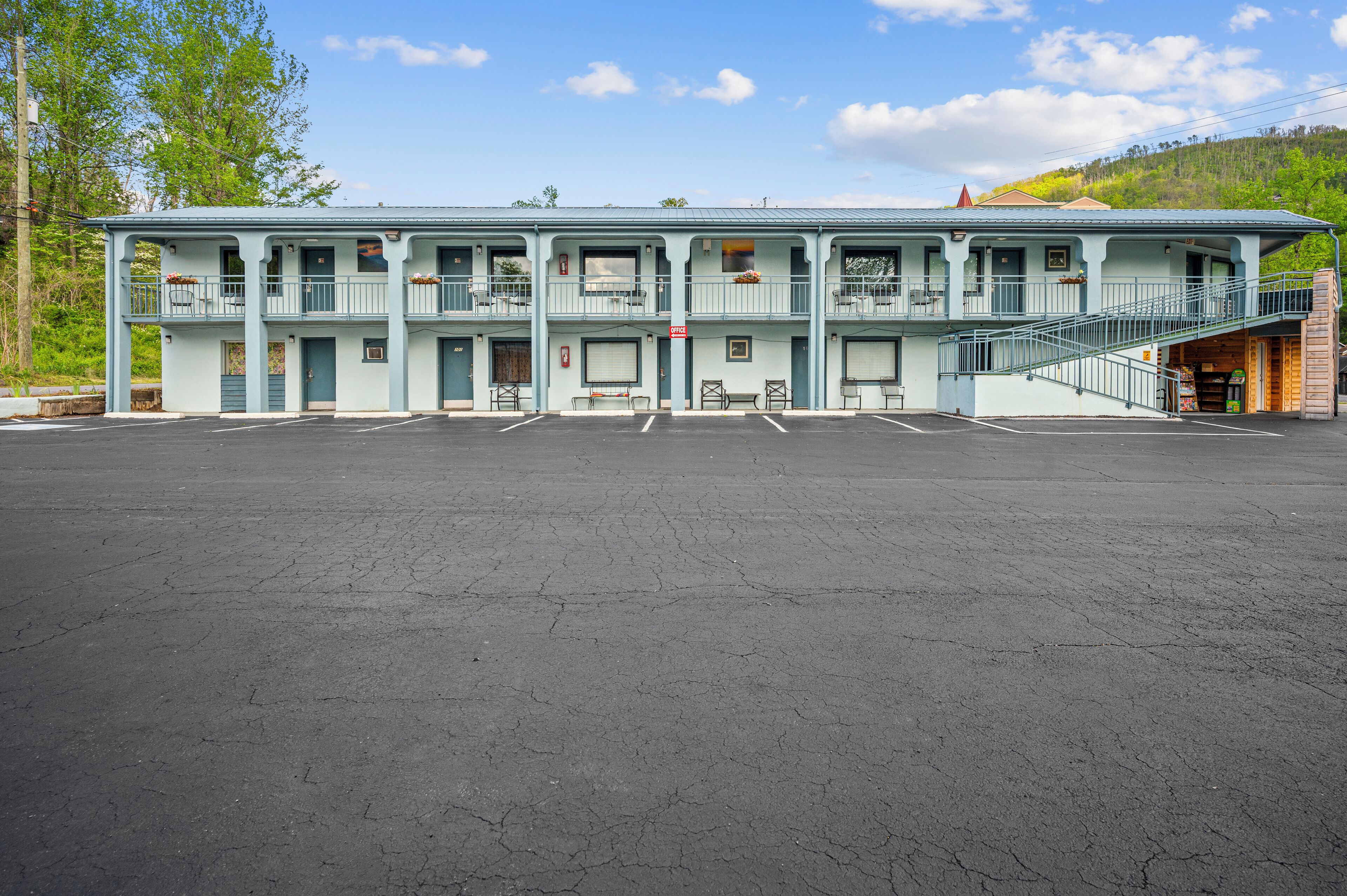 A two-story motel with a parking lot in front.