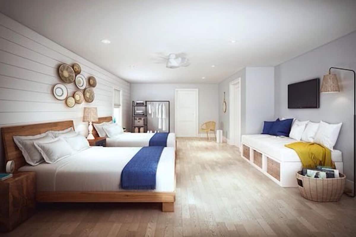 Suite Deluxe, varias camas, para no fumadores, vista al jardín | Sábanas italianas Frette, ropa de cama de alta calidad y edredón