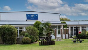 A building with a sign reading 'SAND BAY Holiday Village.'