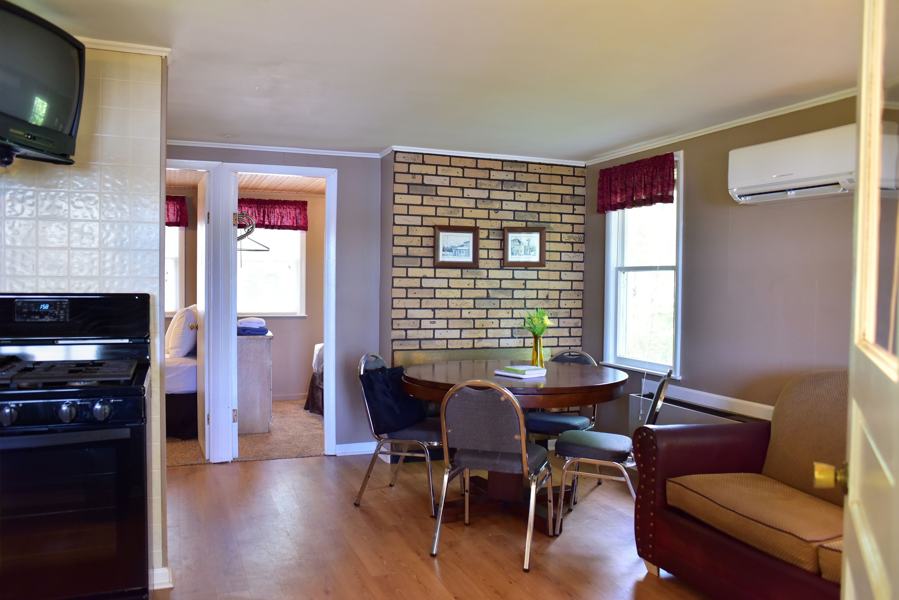 A compact living space with a kitchen, dining area, and seating.