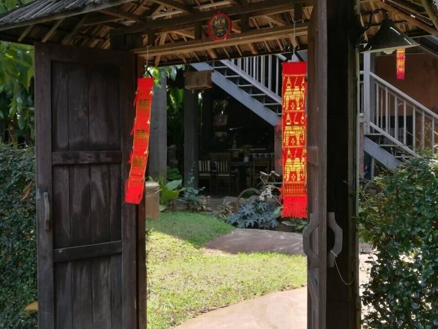 A wooden structure with a metal roof, a staircase, and red decorations.