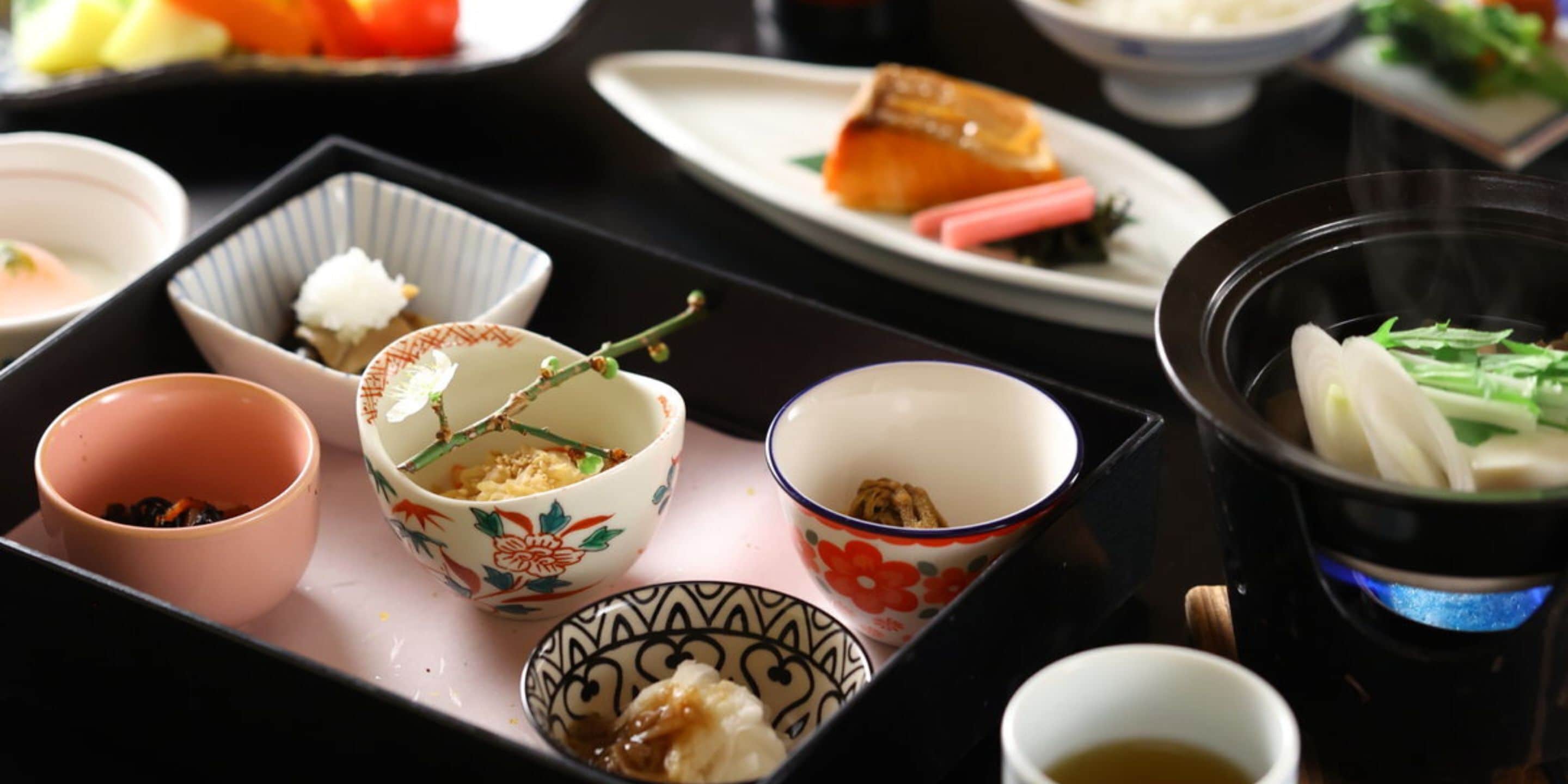 A traditional Japanese meal setup with various dishes and bowls on a tray.