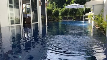 Outdoor pool, an infinity pool, pool loungers