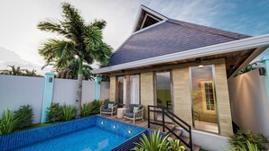 A modern house with a swimming pool, outdoor seating, and a mountain view. - The Orient Beach Boracay (Boracay Island)