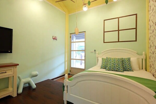 A bedroom with a bed, a small dresser, a television, and a window. - OwlStay GreenVilla (Shoufeng)
