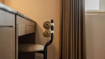 Uma cadeira moderna com design exclusivo, posicionada ao lado de um armário de madeira e uma janela com cortinas.