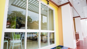 A modern building with large windows, a covered outdoor area, and a tiled entrance. - Takanta Place (Udon Thani)