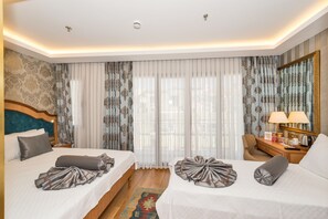 A hotel room with two beds, a desk, a chair, a mirror, and a window with curtains. - Aprilis Gold Hotel - Special Class (Istanbul)