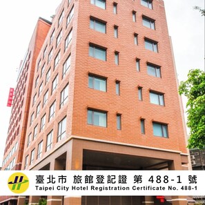A multi-story hotel building with a brick facade, numerous windows, and a visible entrance. - Riverview Suites Taipei (Taipei)